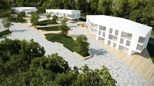 Ein Hof mit grünen Bauminseln. Dahinter befinden sich simulierte Häuser für den InnovationCampus.